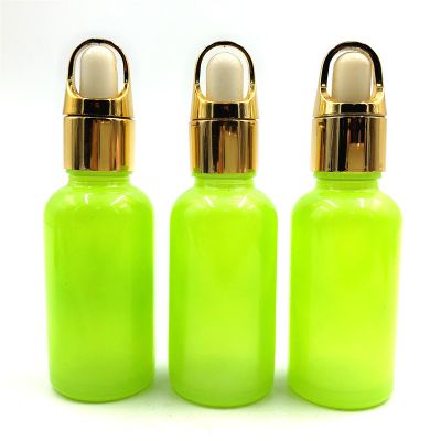 OEM/ODM 50ml light colorful empty essential oil glass bottle with stopper and golden lids