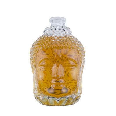 Unique design buddha head shape high flint 750ml alcohol glass bottles for vodka whisky with cork top