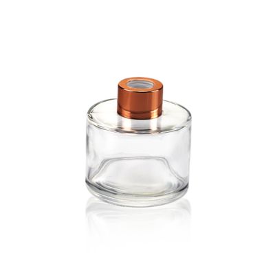 China factory cheap 100ml round glass aroma diffuser bottles with rose gold cap 