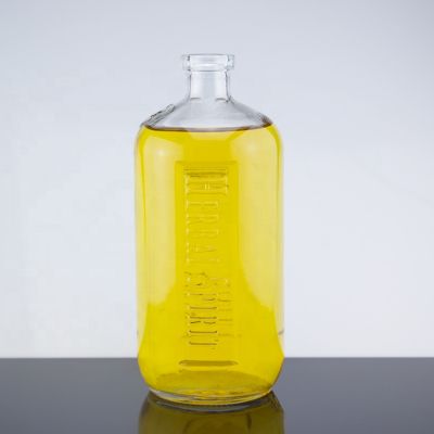 Embossed Design 750ml Round Shape Empty Transparent Liquor Glass Bottle With Corks 