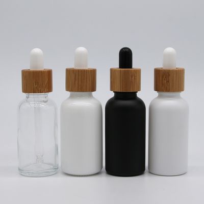 frosted matte black glass CBD essential oil Glass dropper bottles White porcelain essence bottle Round bamboo cosmetic packaging