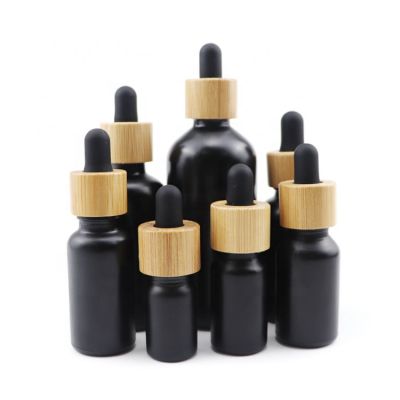 empty 30 ml 1 oz cosmetic essential hair oil bottles 30ml cuticle frosted black glass dropper bottle with bamboo lid top for cbd