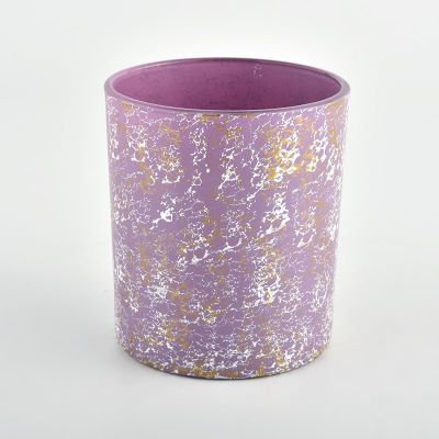 purple glass vessels for candles with golden decoration