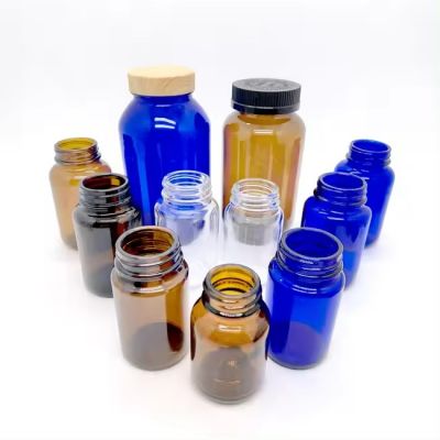 wholesale Recyclable dark Amber glass capsule bottles Heavy Glass Wide Mouth Packer Medicine Glass Bottles with Caps Liner
