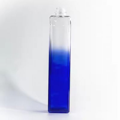 Long multi-pronged blue and white screen printed spirits glass bottle