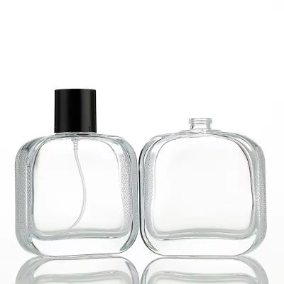 Luxury Saudi Arabia Flat Embossment Black Cap 100ml Bottle Wholesale Transparent Glass Perfume Bottle With Pump Sprayer